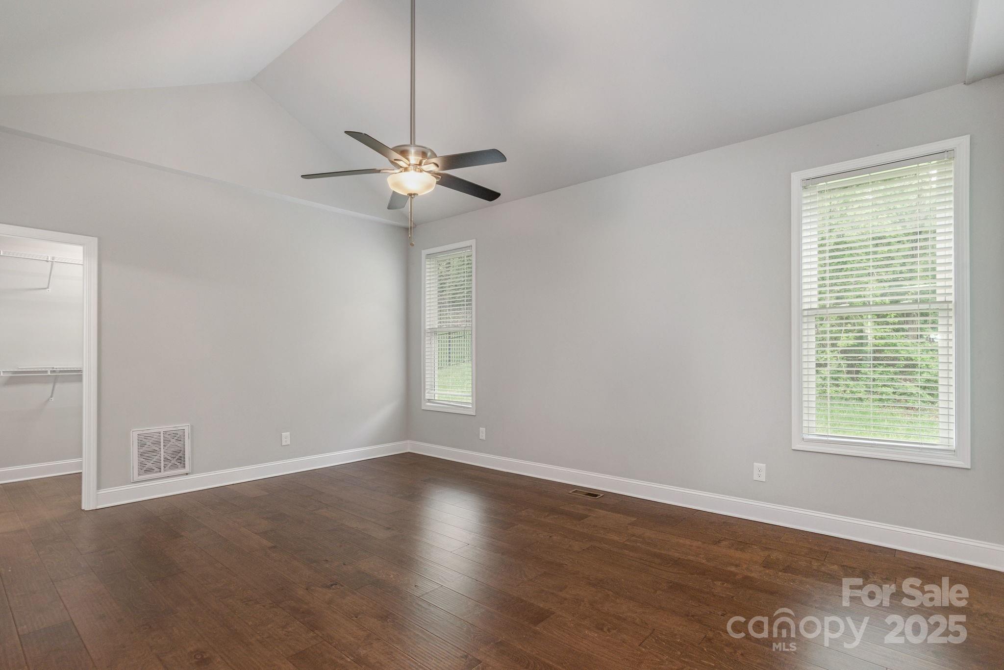 76 Tryon View Drive Flat Rock, NC 28731 - Photo 16 of 30 a view of an empty room with a window and wooden floor