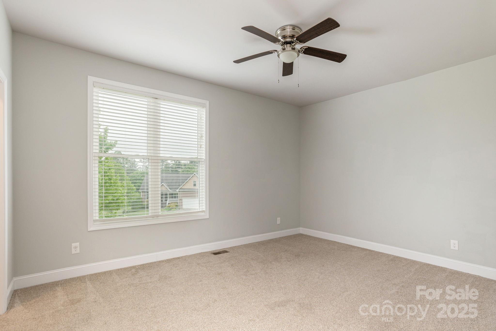 76 Tryon View Drive Flat Rock, NC 28731 - Photo 21 of 30 an empty room with a window and a fan
