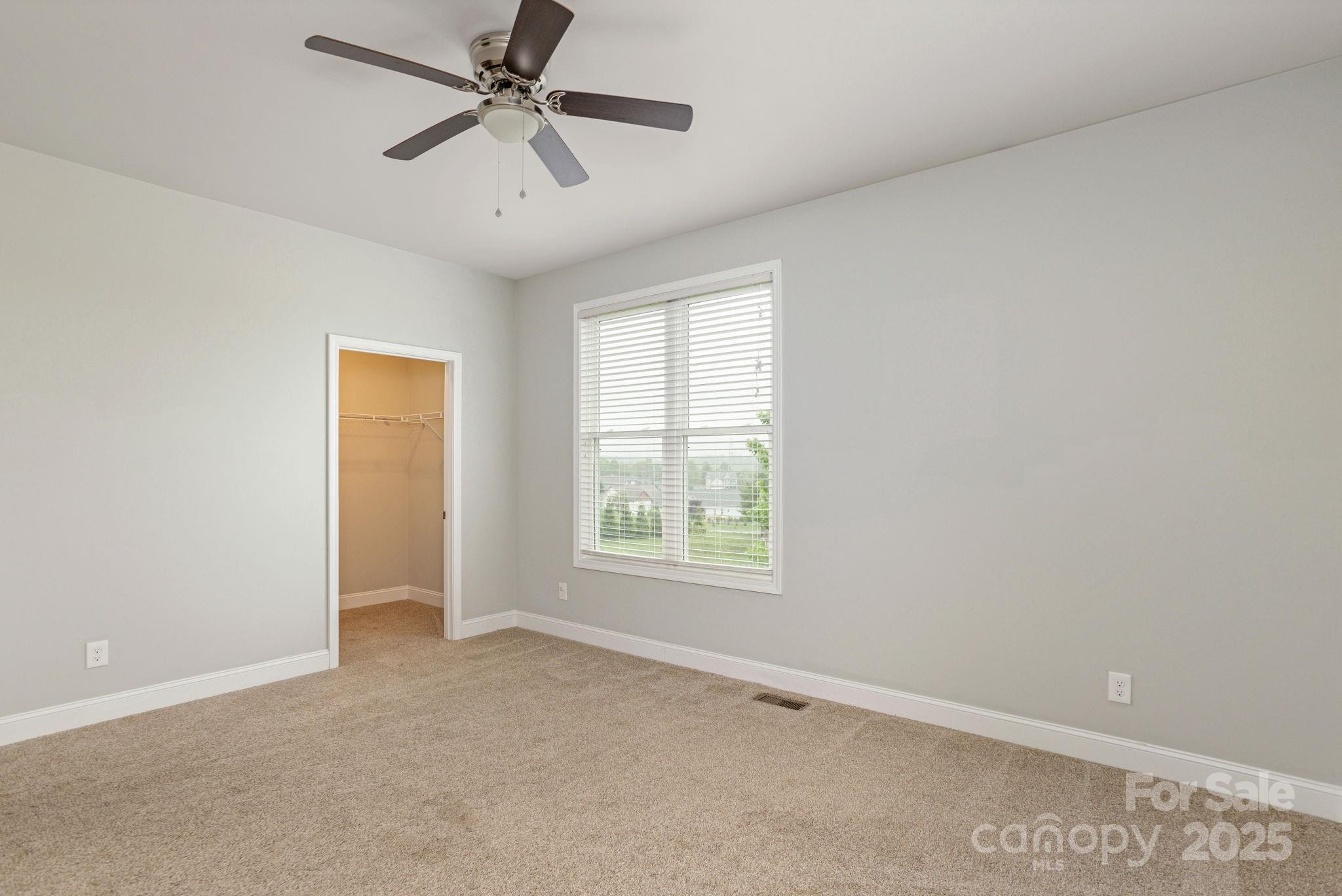 76 Tryon View Drive Flat Rock, NC 28731 - Photo 22 of 30 an empty room with windows and fan