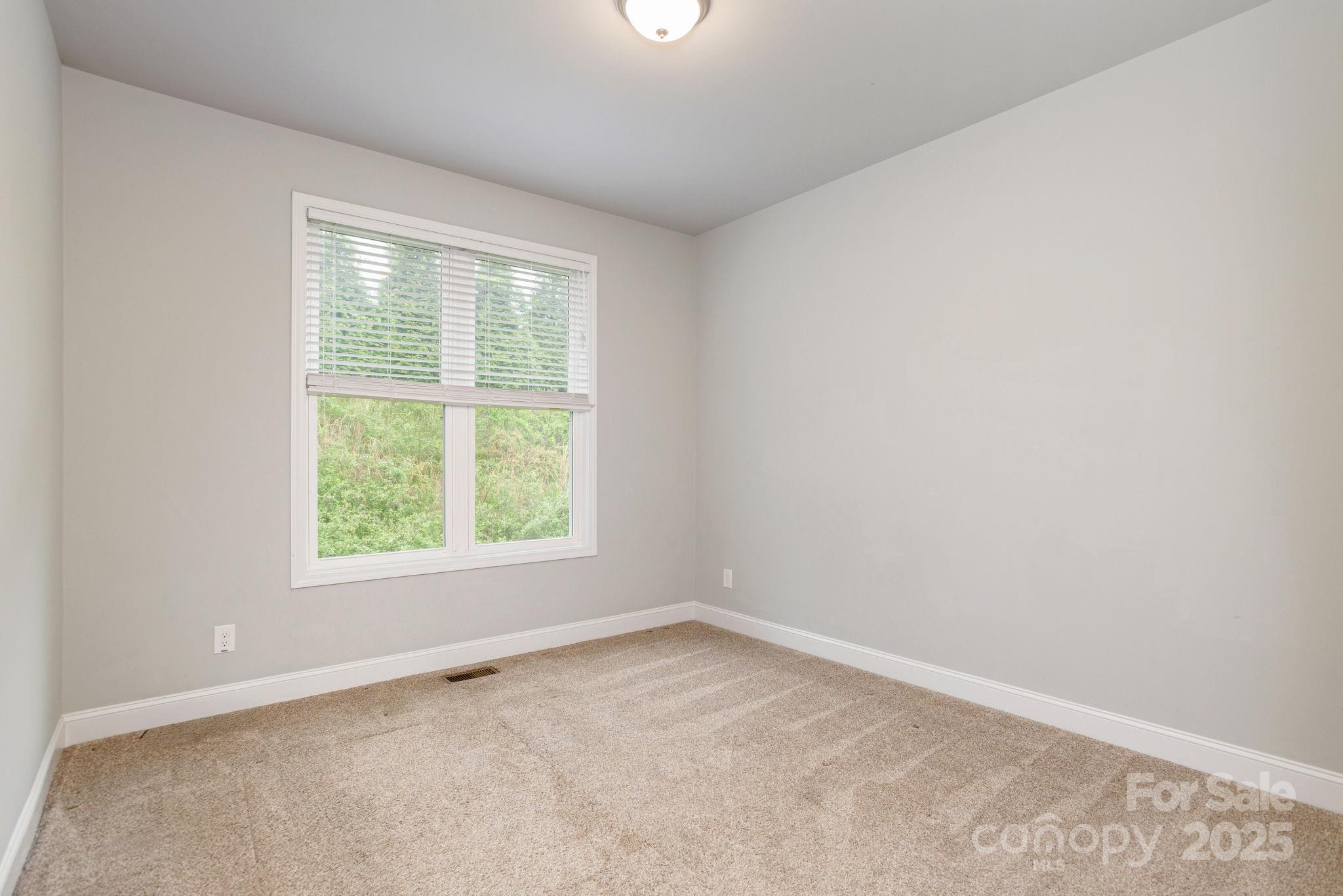 76 Tryon View Drive Flat Rock, NC 28731 - Photo 24 of 30 an empty room with a window