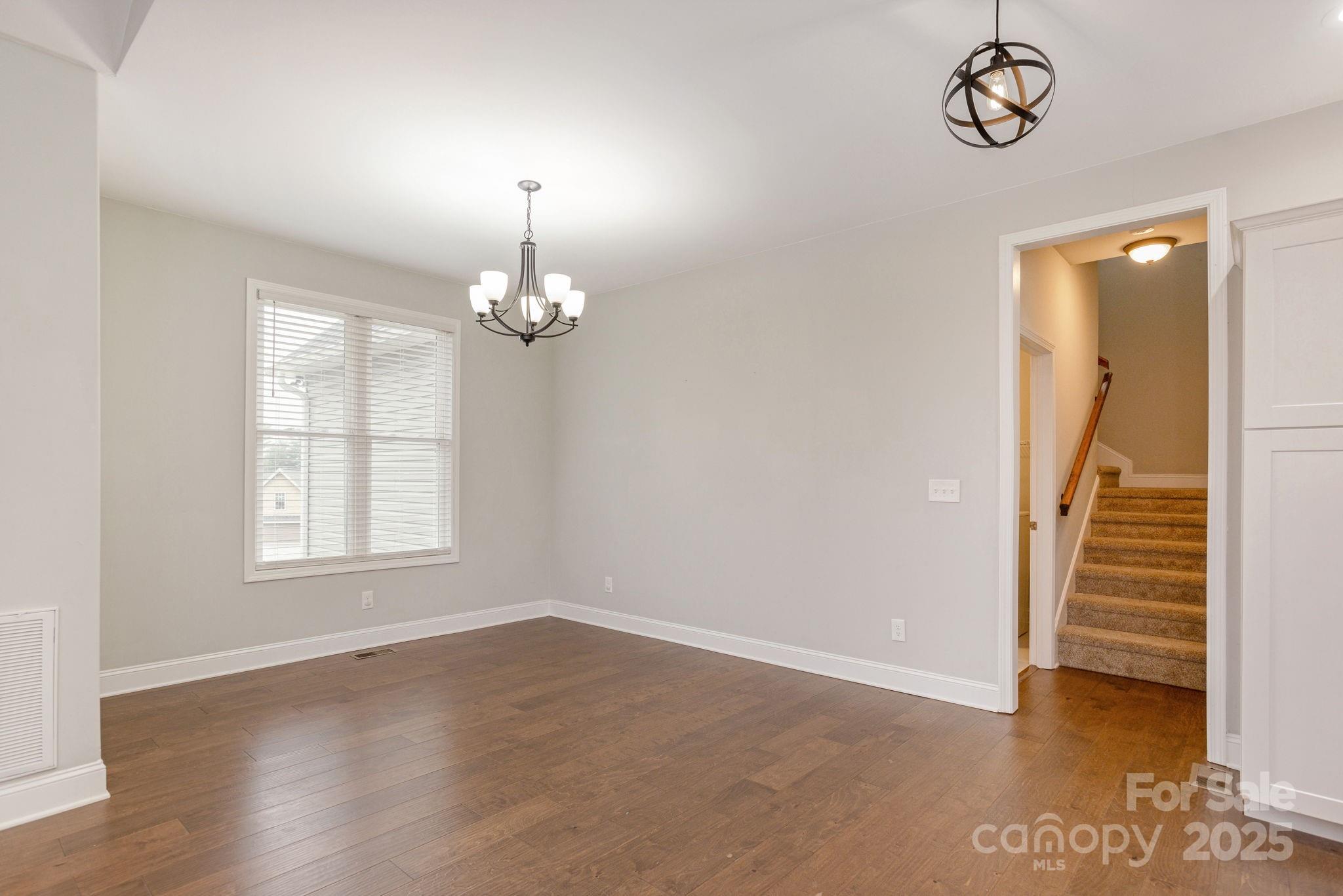 76 Tryon View Drive Flat Rock, NC 28731 - Photo 5 of 30 an empty room with wooden floor fan and windows