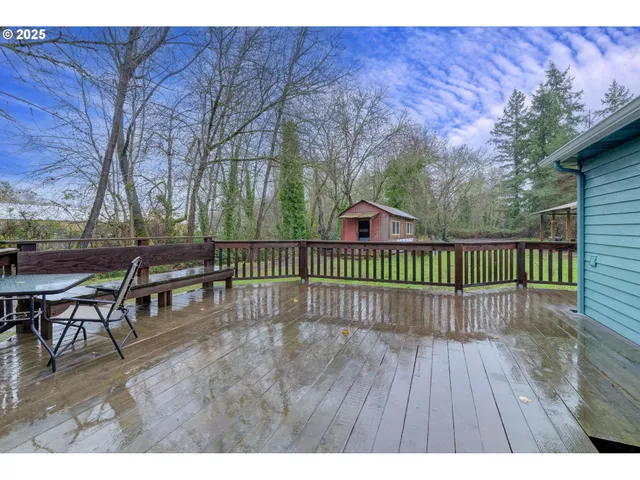 a view of backyard with a deck and wooden floor