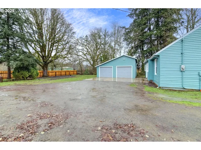 a view of a house with a yard and garage