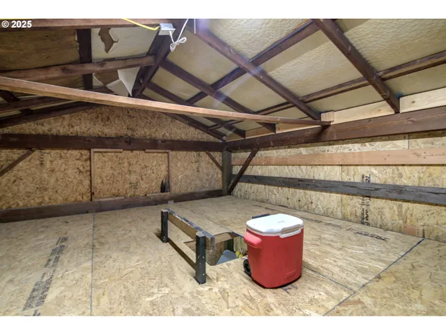 a water heater room with wooden floor