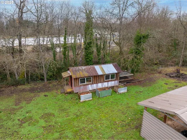 a aerial view of a house with pool and a yard