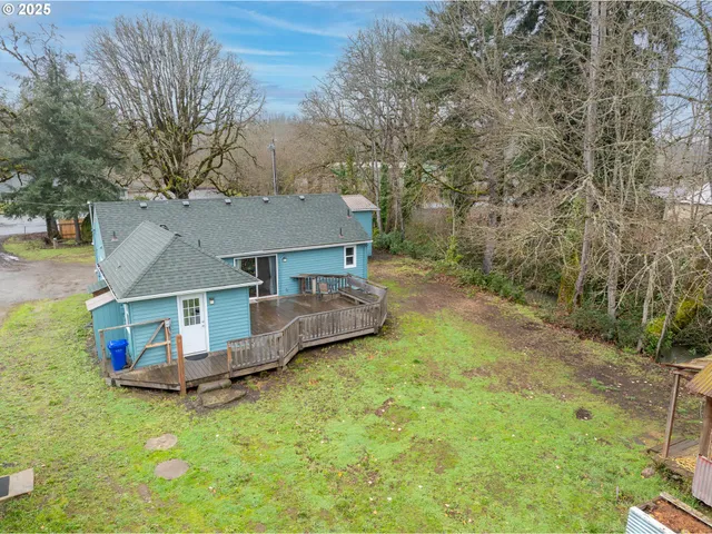 a view of a house with a yard and sitting area