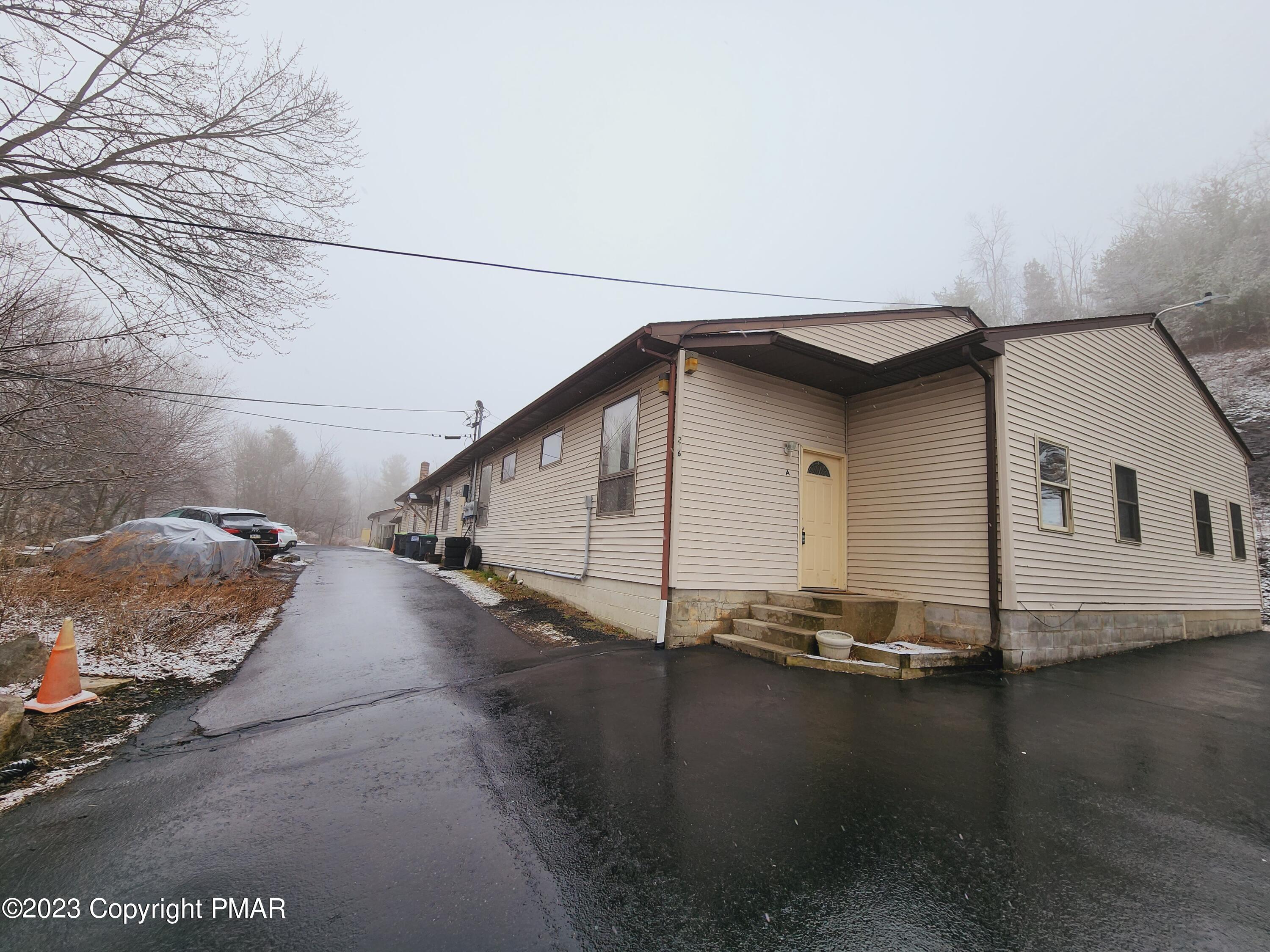 216 Friemann Lane Sciota, PA 18354 - Photo 1 of 7 a house with river in front of it