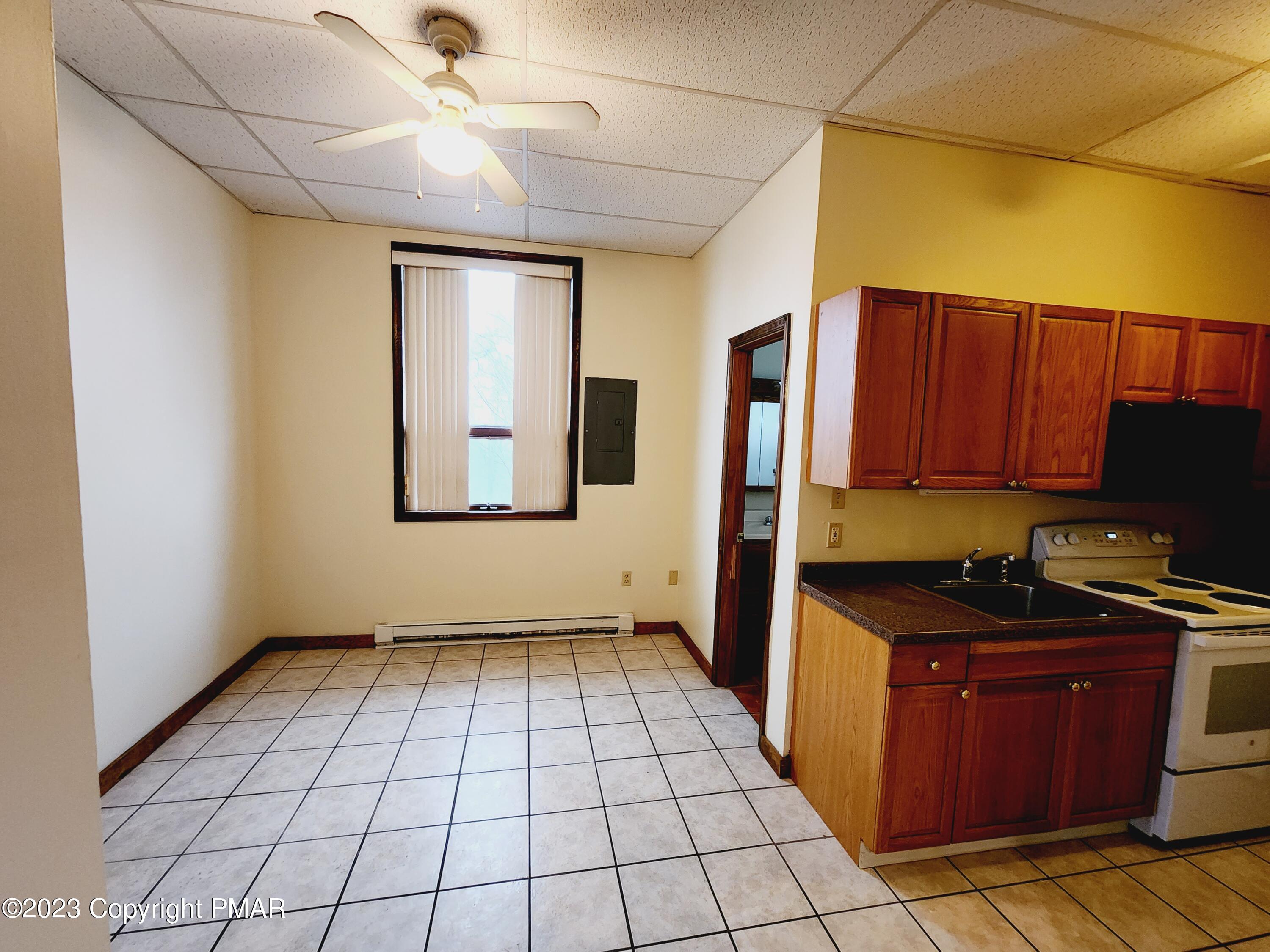 216 Friemann Lane Sciota, PA 18354 - Photo 2 of 7 a kitchen with a stove a sink and a refrigerator