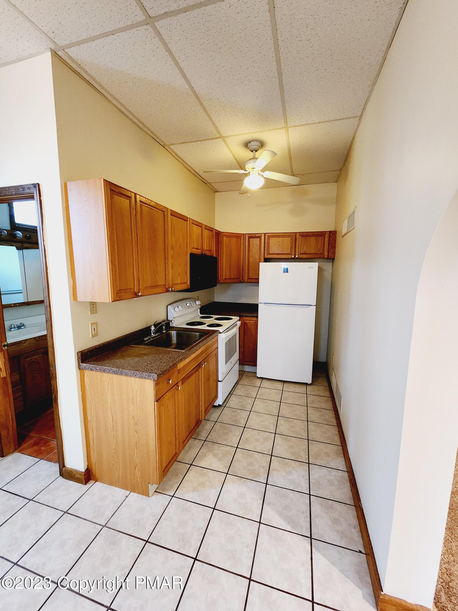 216 Friemann Lane Sciota, PA 18354 - Photo 3 of 7 a kitchen with stainless steel appliances cabinets a sink and a stove