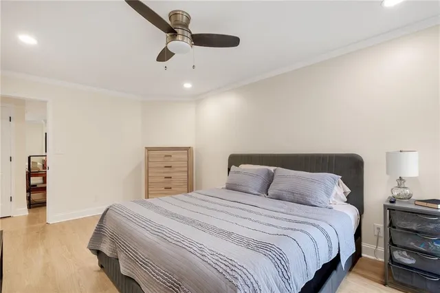 a bedroom with a bed and a ceiling fan