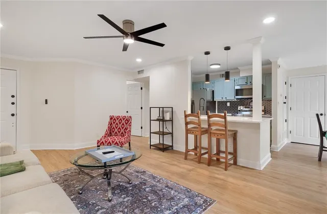 a living room with furniture and kitchen view