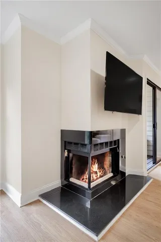 a living room with a fireplace and a flat screen tv