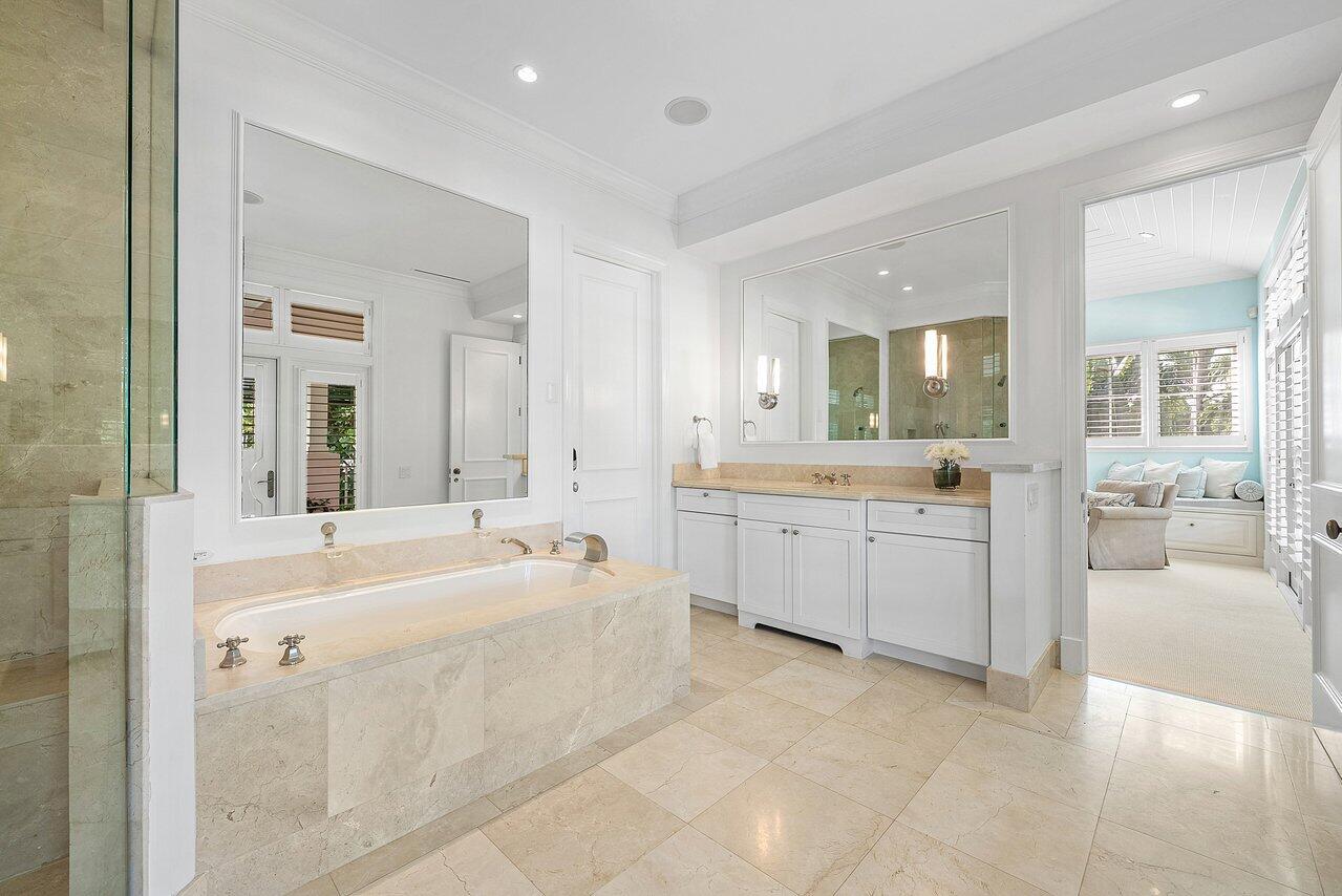 3138 Gulf Stream Road Gulf Stream, FL 33483 - Photo 20 of 49 a large white bathroom with a large tub sink shower and mirror