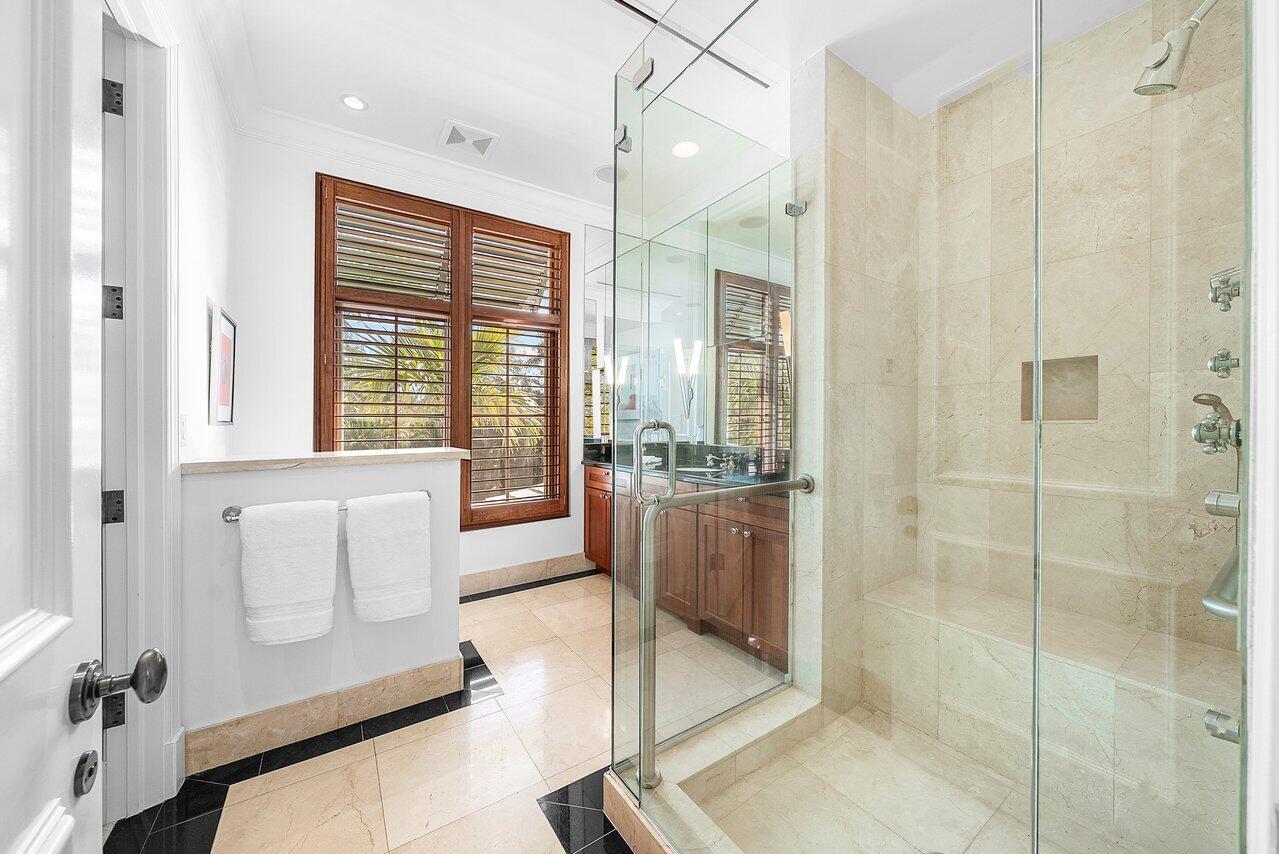 3138 Gulf Stream Road Gulf Stream, FL 33483 - Photo 21 of 49 a bathroom with a double vanity sink and mirror