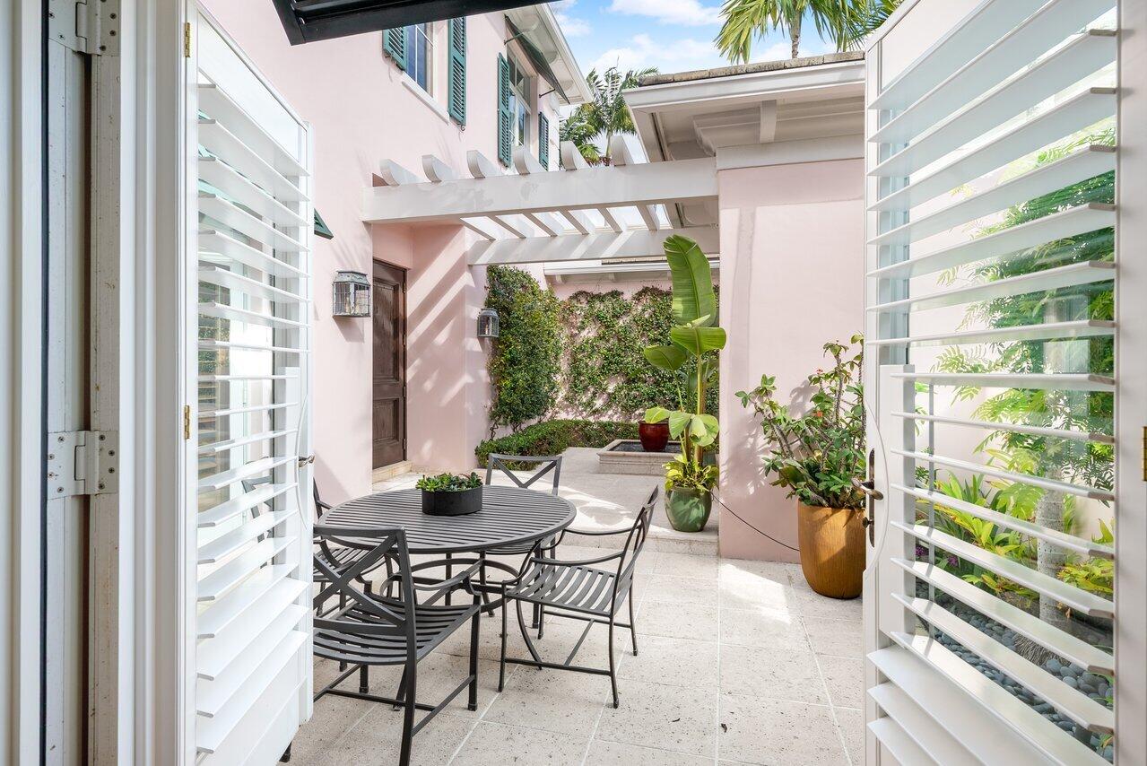 3138 Gulf Stream Road Gulf Stream, FL 33483 - Photo 26 of 49 a view of a patio with a table and chairs and potted plants