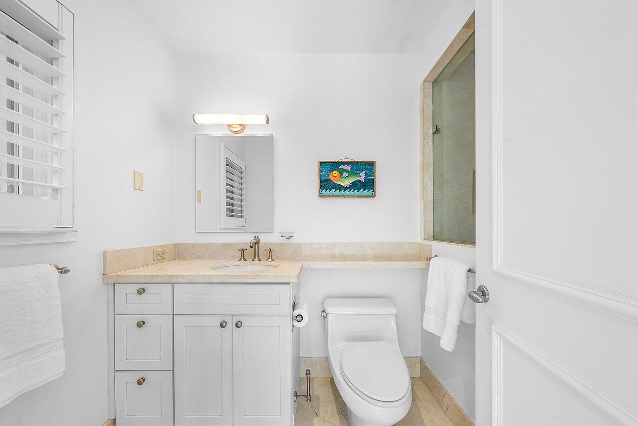 3138 Gulf Stream Road Gulf Stream, FL 33483 - Photo 38 of 49 a bathroom with a toilet a sink and mirror