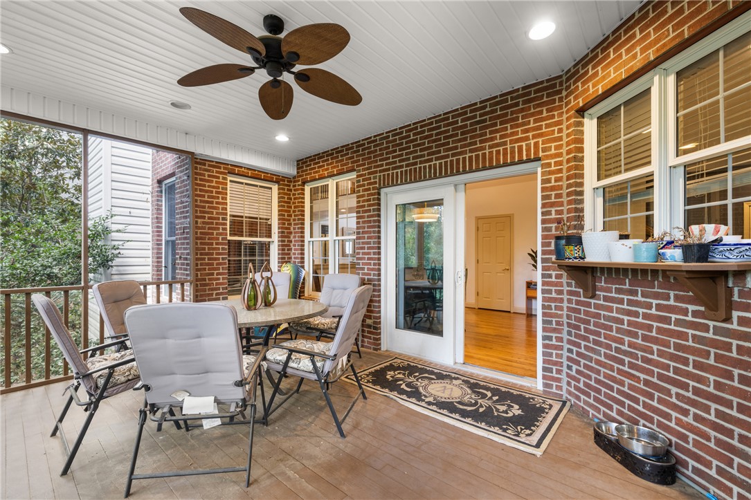 106 Red Maple Way Clemson, SC 29631 - Photo 10 of 49 Exposed brick walls and rich wood flooring enhance this screened back porch retreat.