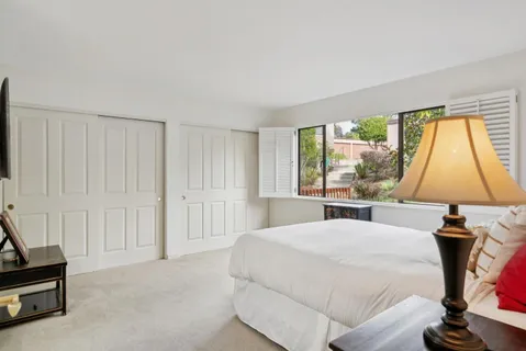 a bedroom with a bed and a window