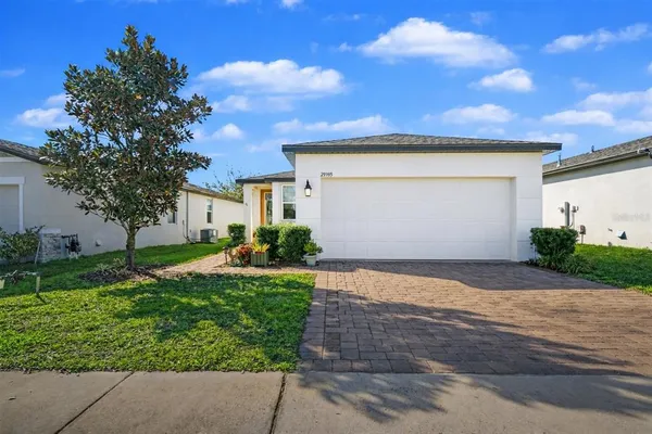 a front view of a house with a yard and garage