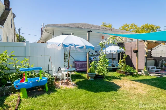 a front view of a house with a yard and outdoor seating