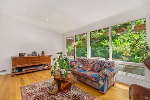 a living room with furniture and a pool table