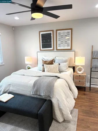 a bedroom with a bed and wooden floor