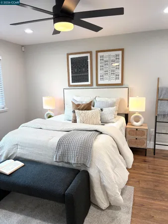 a bedroom with a bed and wooden floor