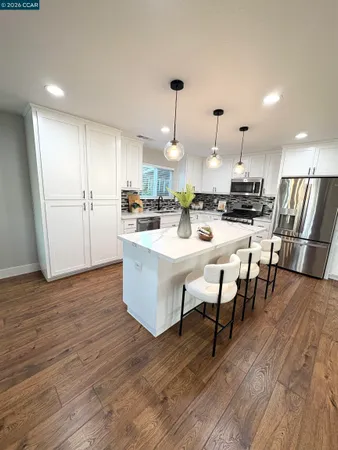 a large kitchen with a table and chairs