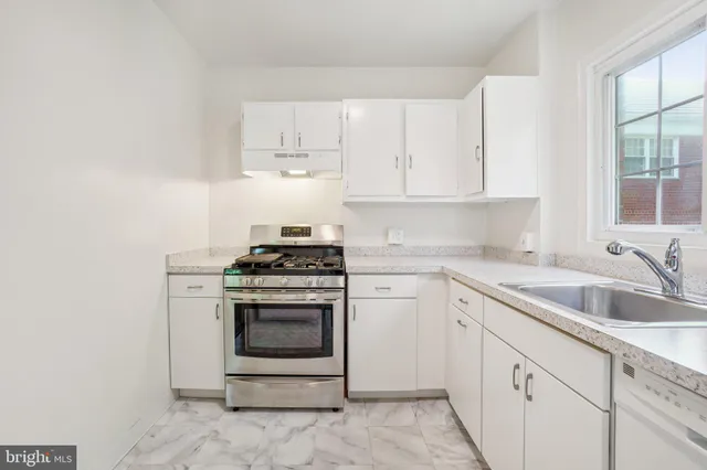 a kitchen with cabinets appliances and a sink