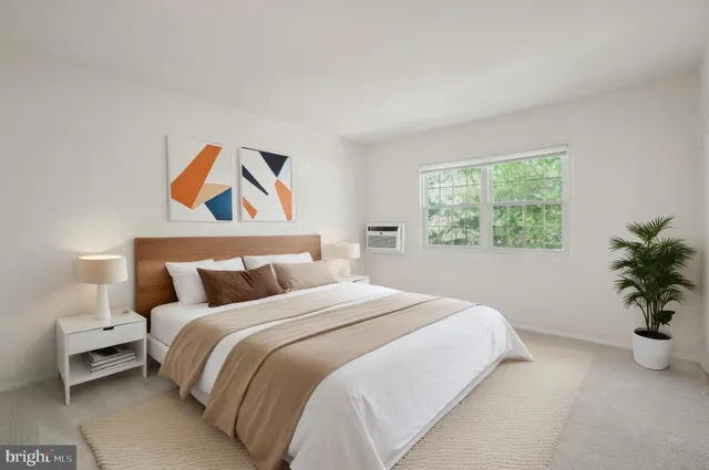 a bedroom with a bed and a painting on the wall