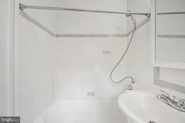 a bathroom with a bath tub with a shower