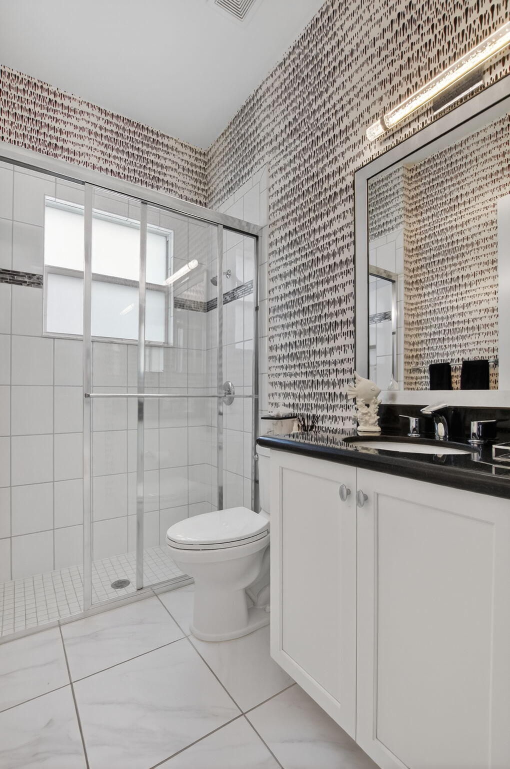 8263 Arabian Range Road Boynton Beach, FL 33473 - Photo 42 of 52 a bathroom with a toilet a sink a mirror and shower