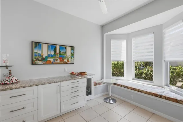 a living room with furniture and a view of kitchen