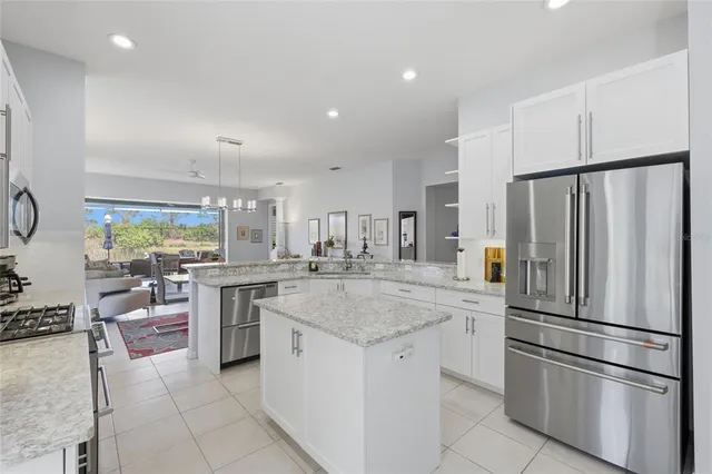 a living room with furniture and a view of kitchen