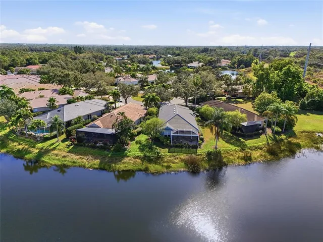 a patio with a table and chairs and potted plants
