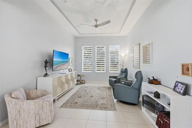 a bedroom with a bed a mirror and a chandelier