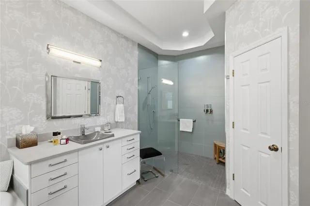 an aerial view of a house with a garden and lake view