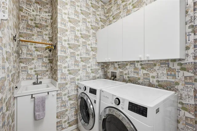 a front view of a house with a yard and fountain in middle