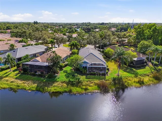 a room with lots of wooden furniture and lots of chairs