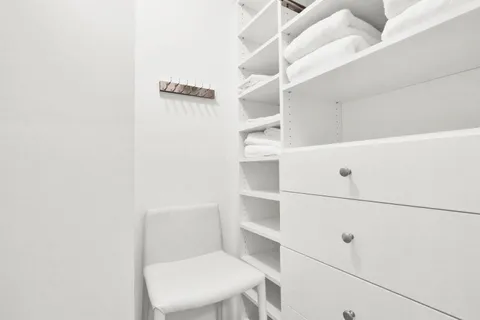 a white toilet sitting next to a shower