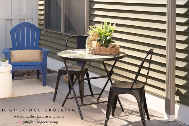 a dining room with furniture and a potted plant