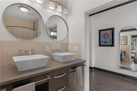 a bathroom with a double vanity sink and a mirror
