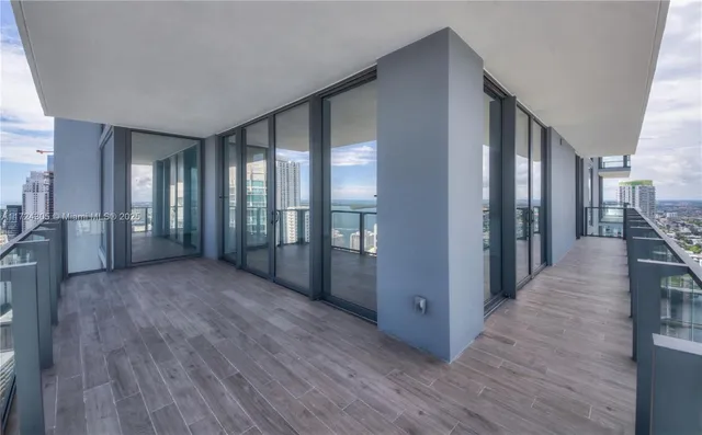 an empty room with sliding door and mountain view