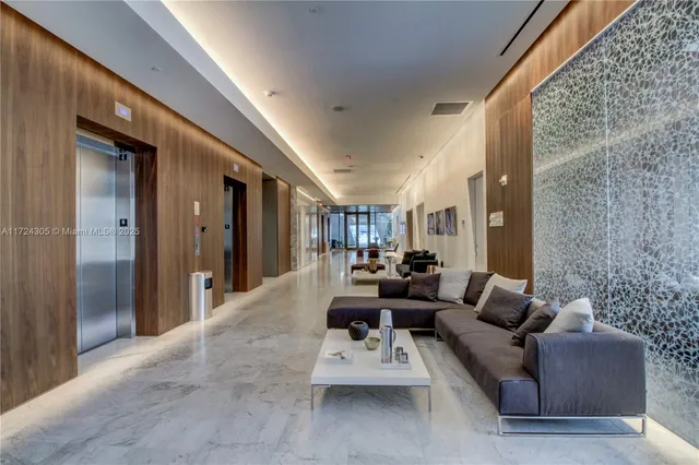 a kitchen with kitchen island granite countertop a sink appliances cabinets and a counter top space