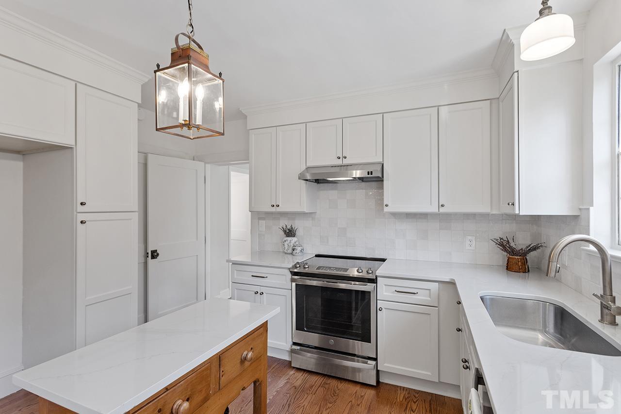 704 Dixie Trail Raleigh, NC 27607 - Photo 14 of 31 a kitchen with stainless steel appliances a sink stove and refrigerator