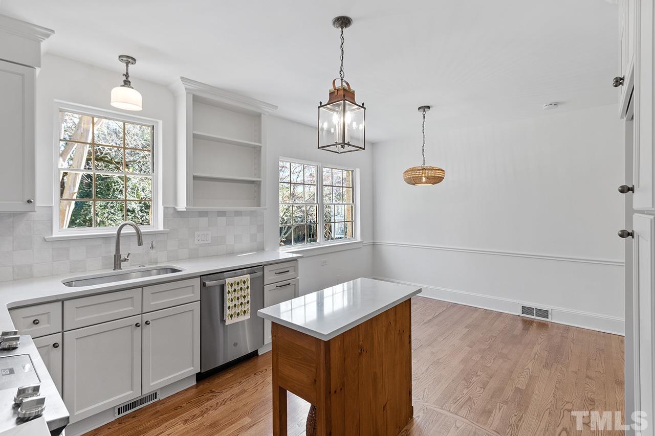 704 Dixie Trail Raleigh, NC 27607 - Photo 17 of 31 a kitchen that has a sink a window and cabinets
