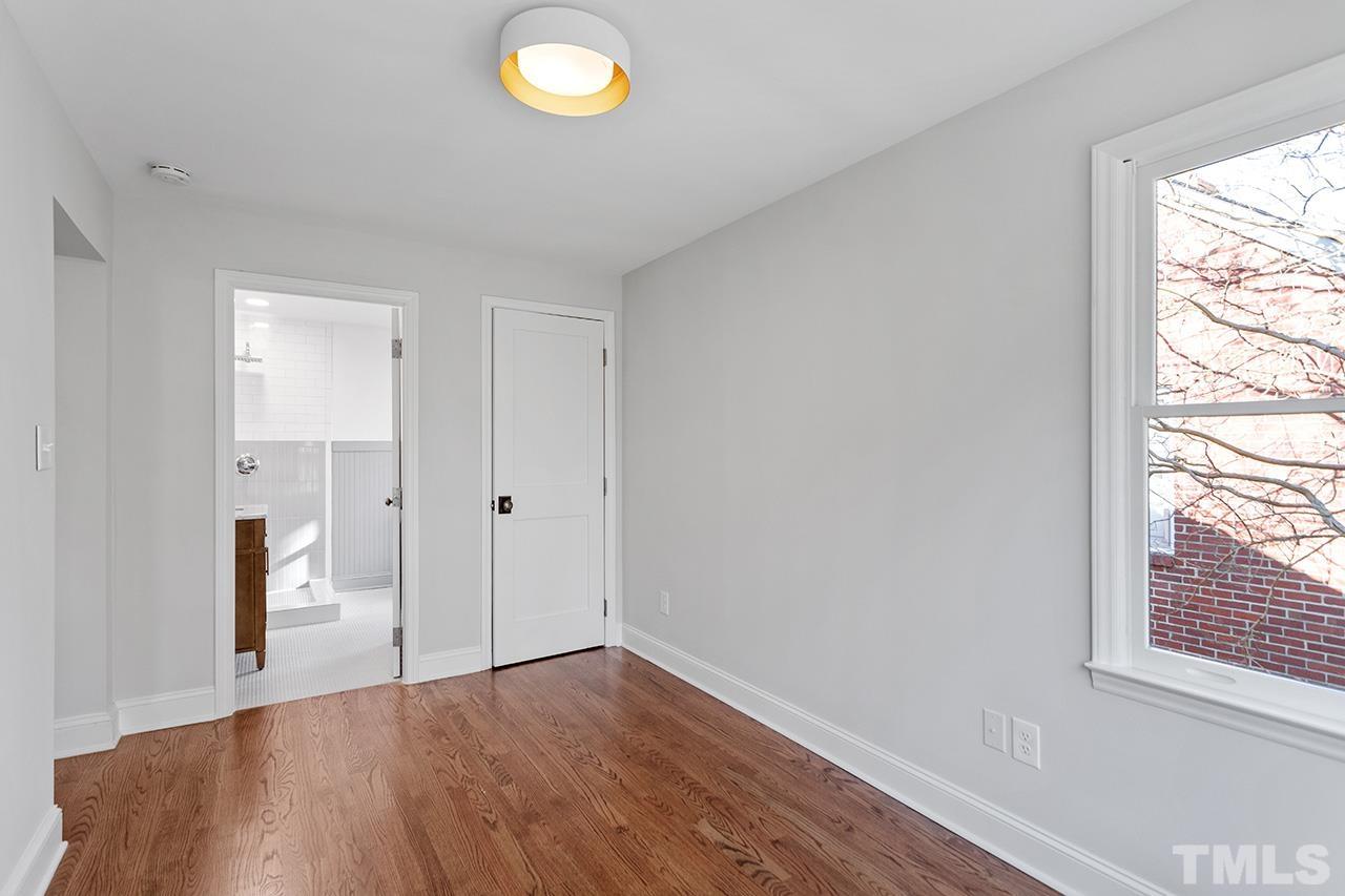 704 Dixie Trail Raleigh, NC 27607 - Photo 20 of 31 an empty room with wooden floor and windows