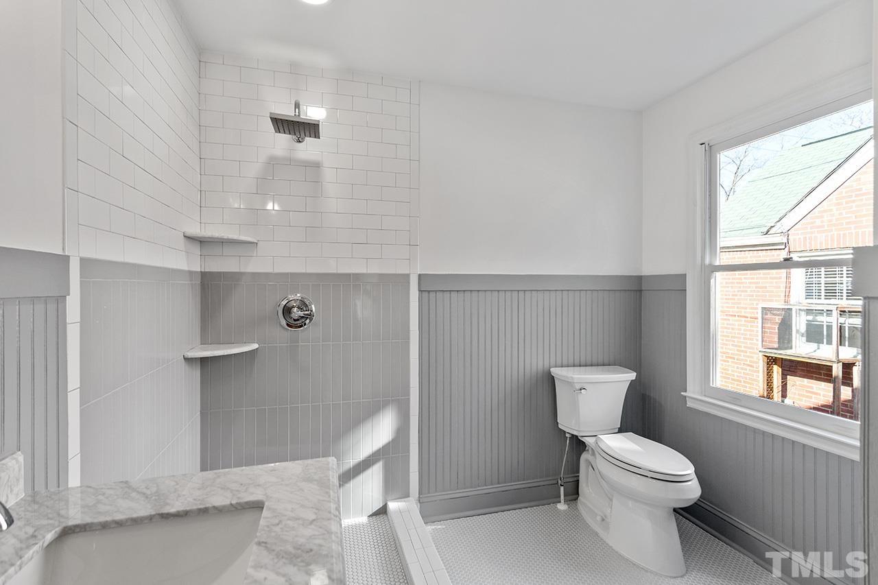 704 Dixie Trail Raleigh, NC 27607 - Photo 21 of 31 a bathroom with a toilet a sink and window