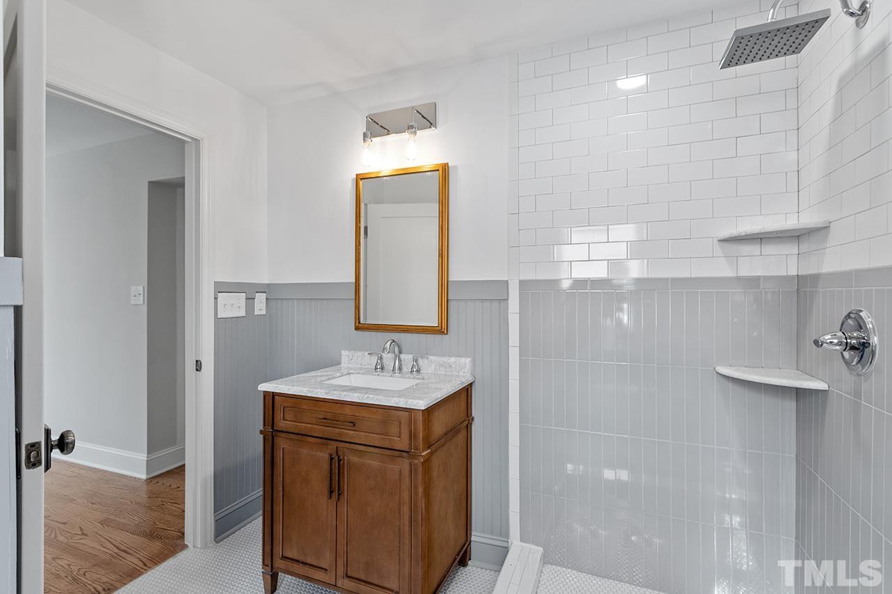 704 Dixie Trail Raleigh, NC 27607 - Photo 22 of 31 a bathroom with a sink a vanity and mirror