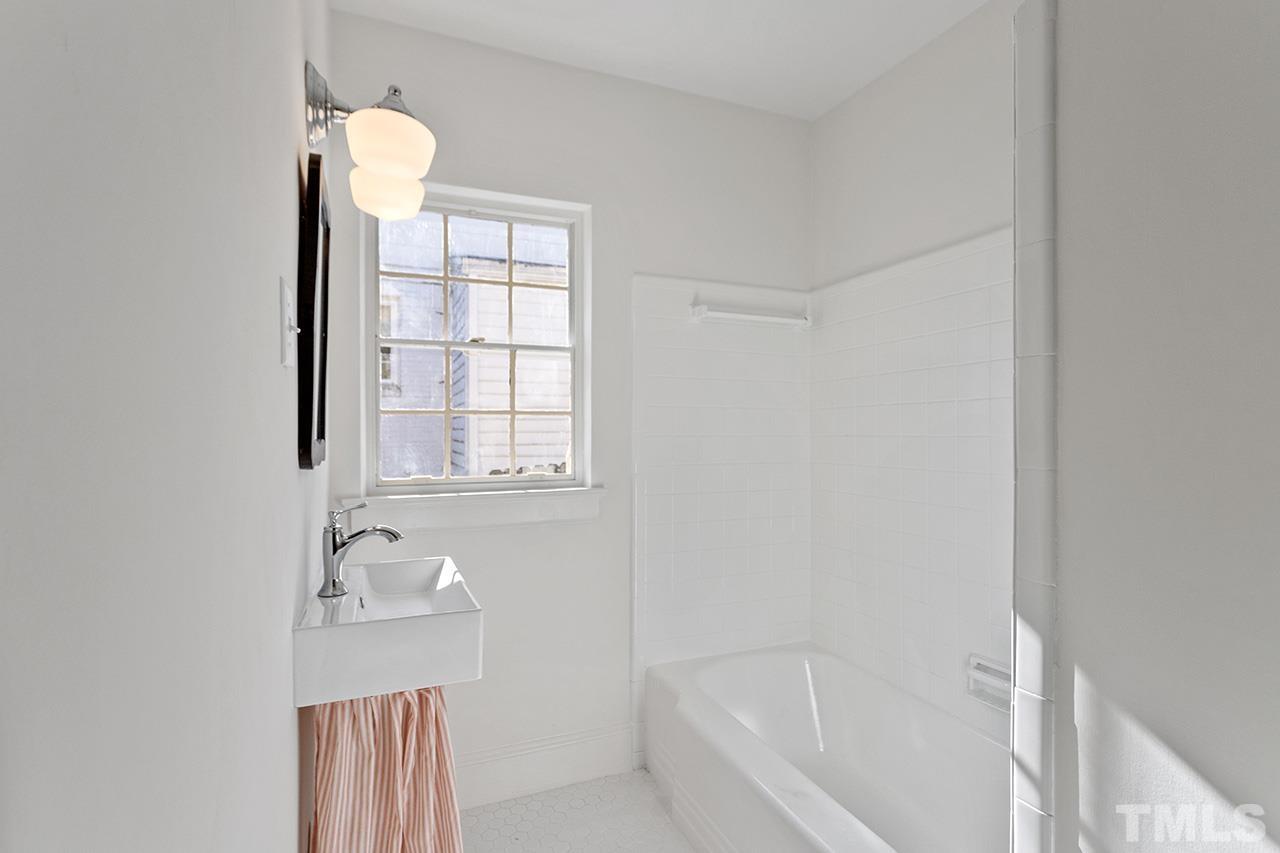 704 Dixie Trail Raleigh, NC 27607 - Photo 25 of 31 a bathroom with a bathtub and window